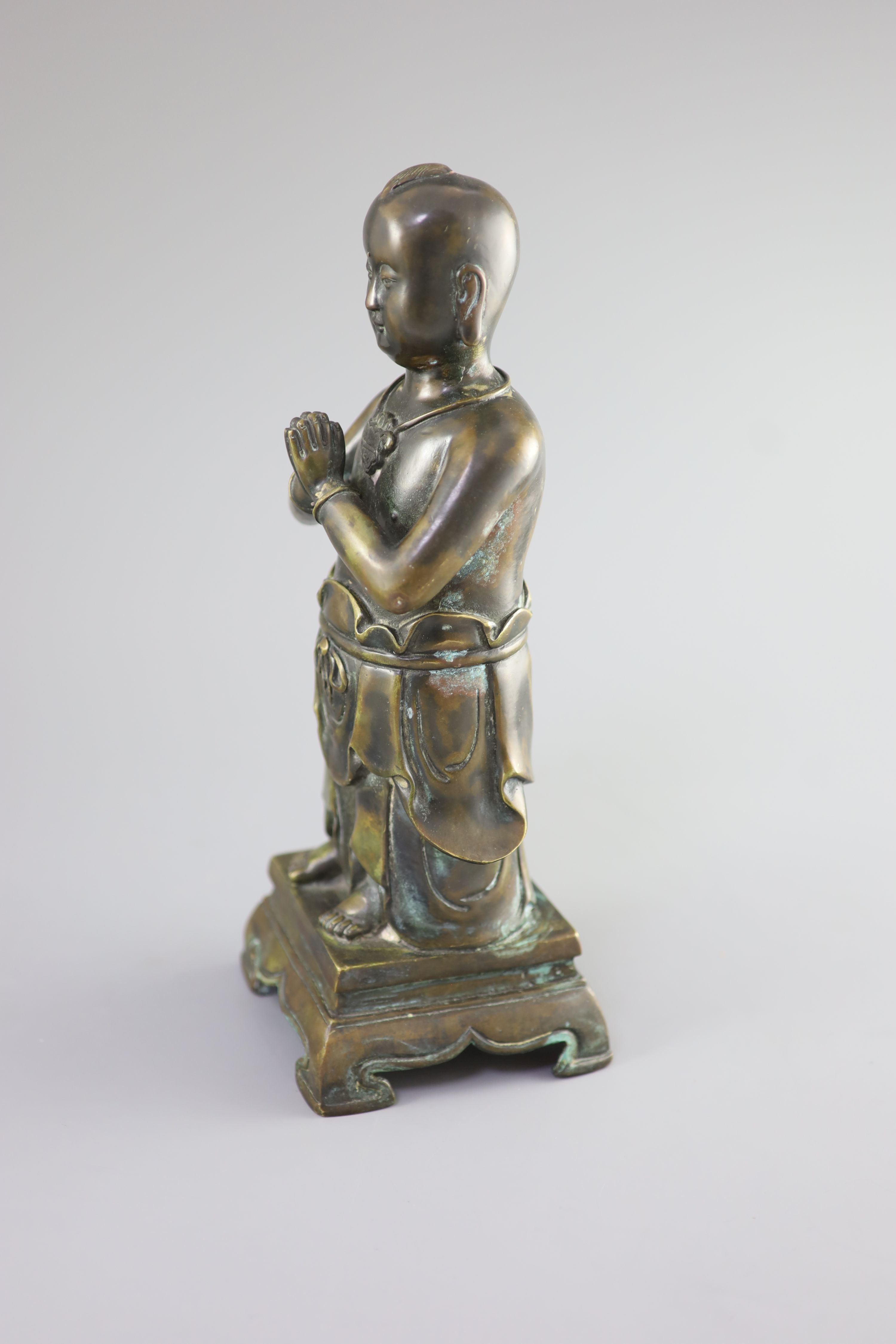 A Chinese bronze standing figure of Shancai Tongzi, 34cm high